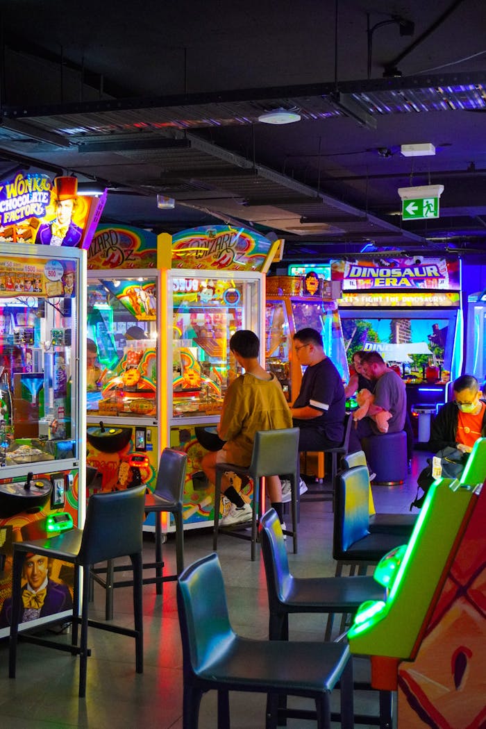 Colorful arcade with people enjoying games. Bright neon lights.